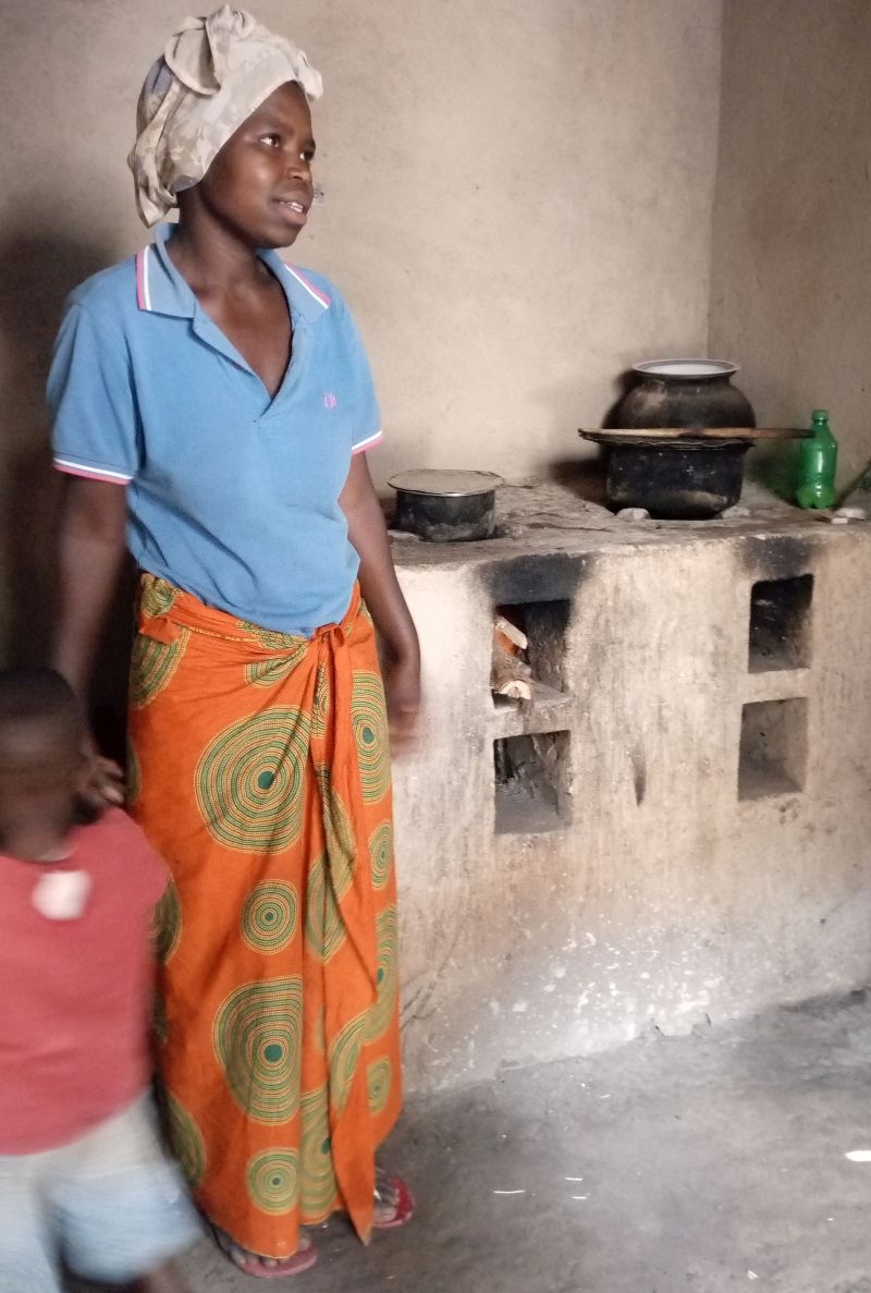 A happy beneficiary of RDIS's Improved Cook Stove