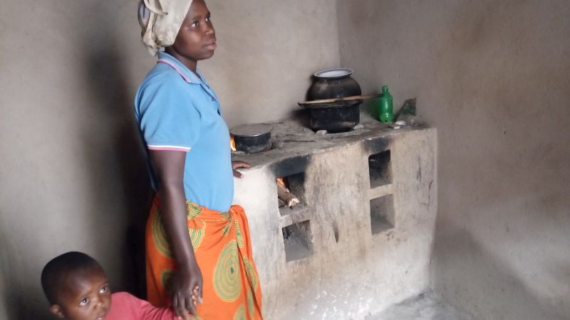 A happy beneficiary of RDIS's Improved Cook Stove