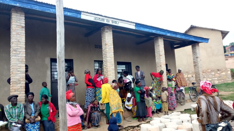 Community members waiting for distribution of Improved Cook Stoves and Ceramic Water Filters